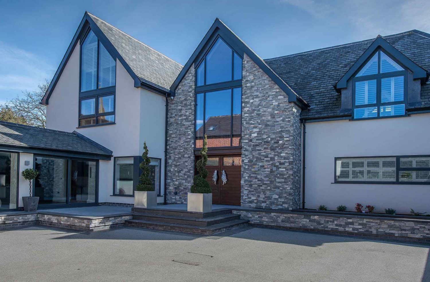 Structural glazing and curtain wall windows on a large contemporary home.