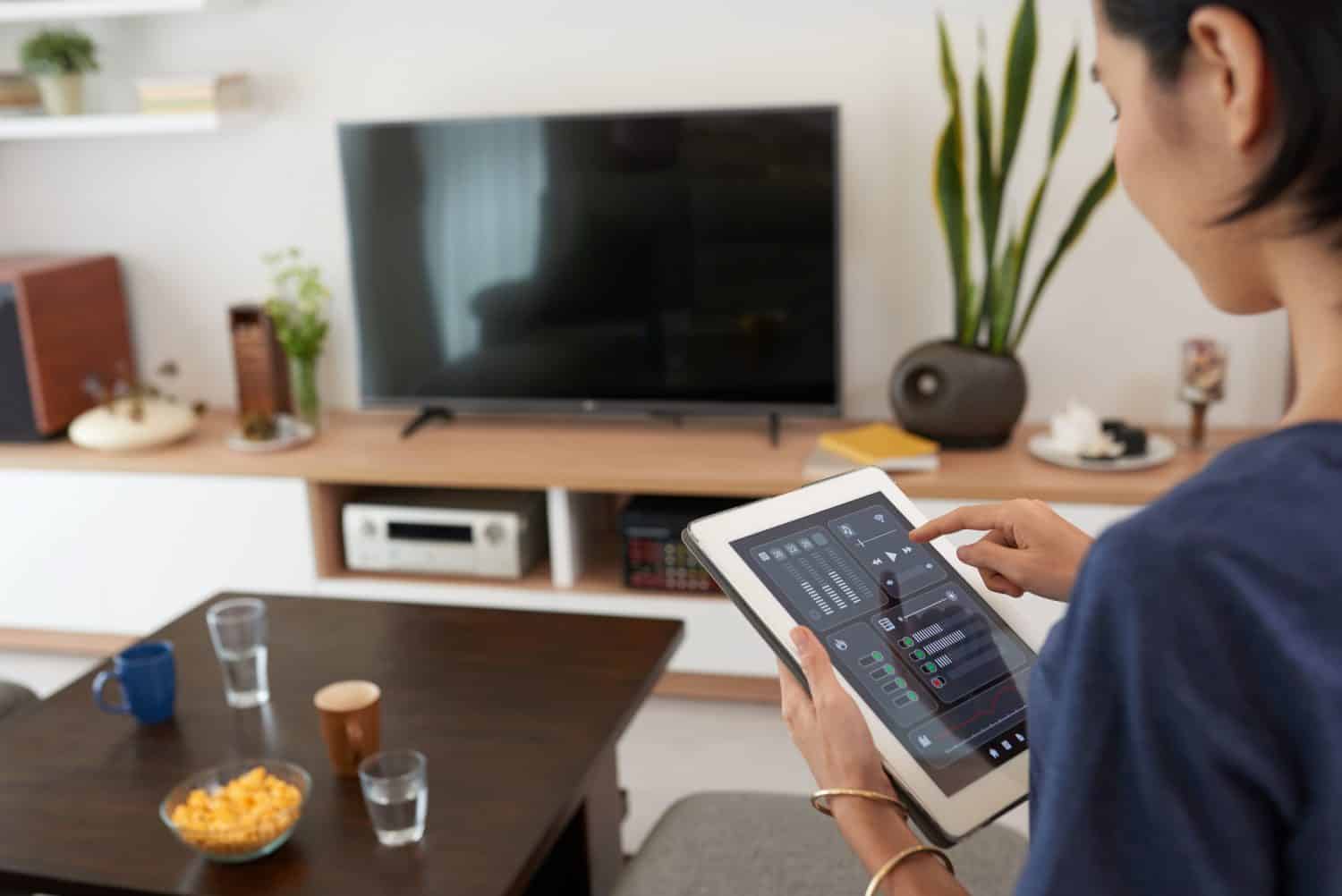 Young woman using application in her smart home