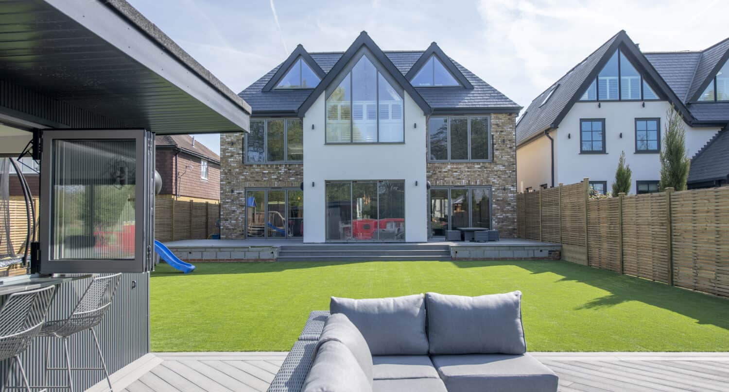 Outdoor garden social space looking at bespoke aluminum windows and doors