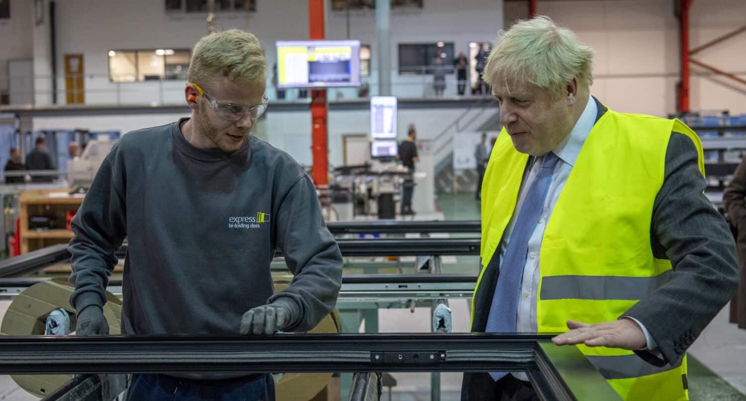 Boris Johnson and a windows technician supervising the work on an aluminium window