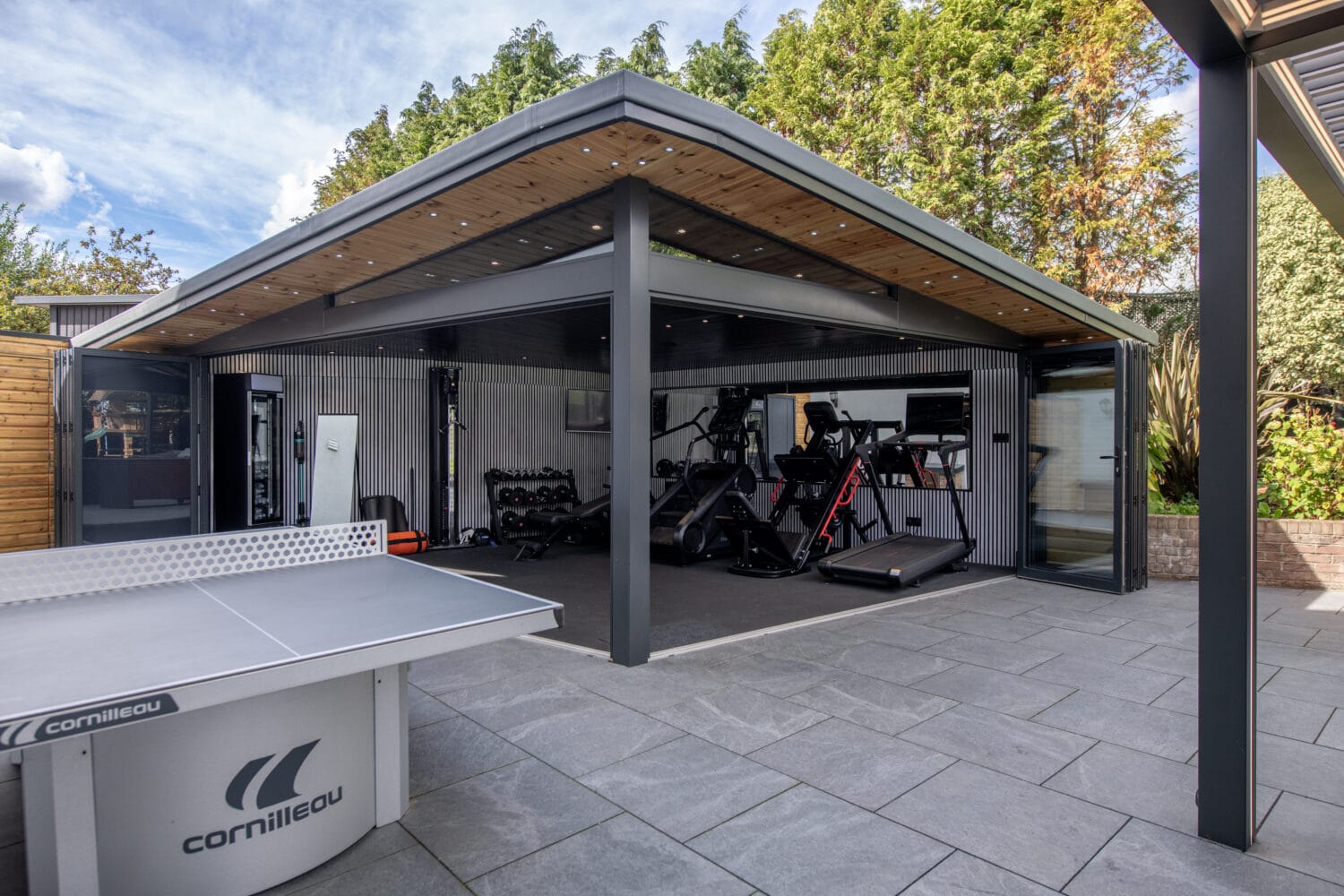 Bi-Folding doors opening to a stylish outdoor gym area in Harrogate.