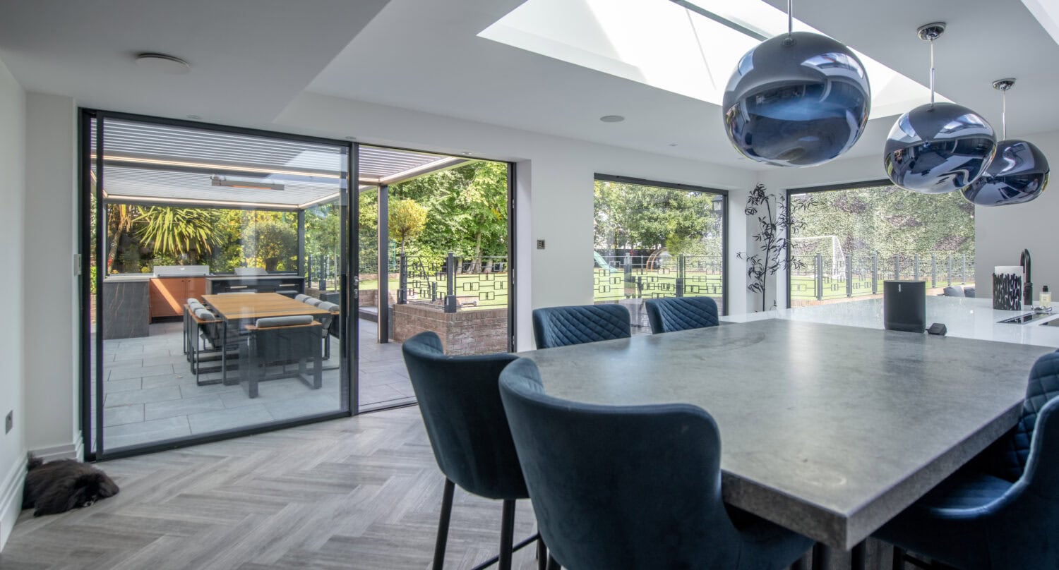 High-quality bi-folding doors opening to a spacious outdoor patio, enhancing natural light and indoor-outdoor flow in a contemporary home in Leadhall Lane, Harrogate.