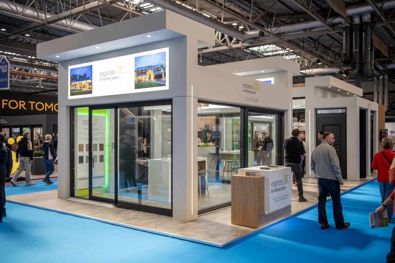 Showcasing modern bi-folding doors at a trade exhibition, highlighting their sleek design and functionality for stylish home or commercial space upgrades.