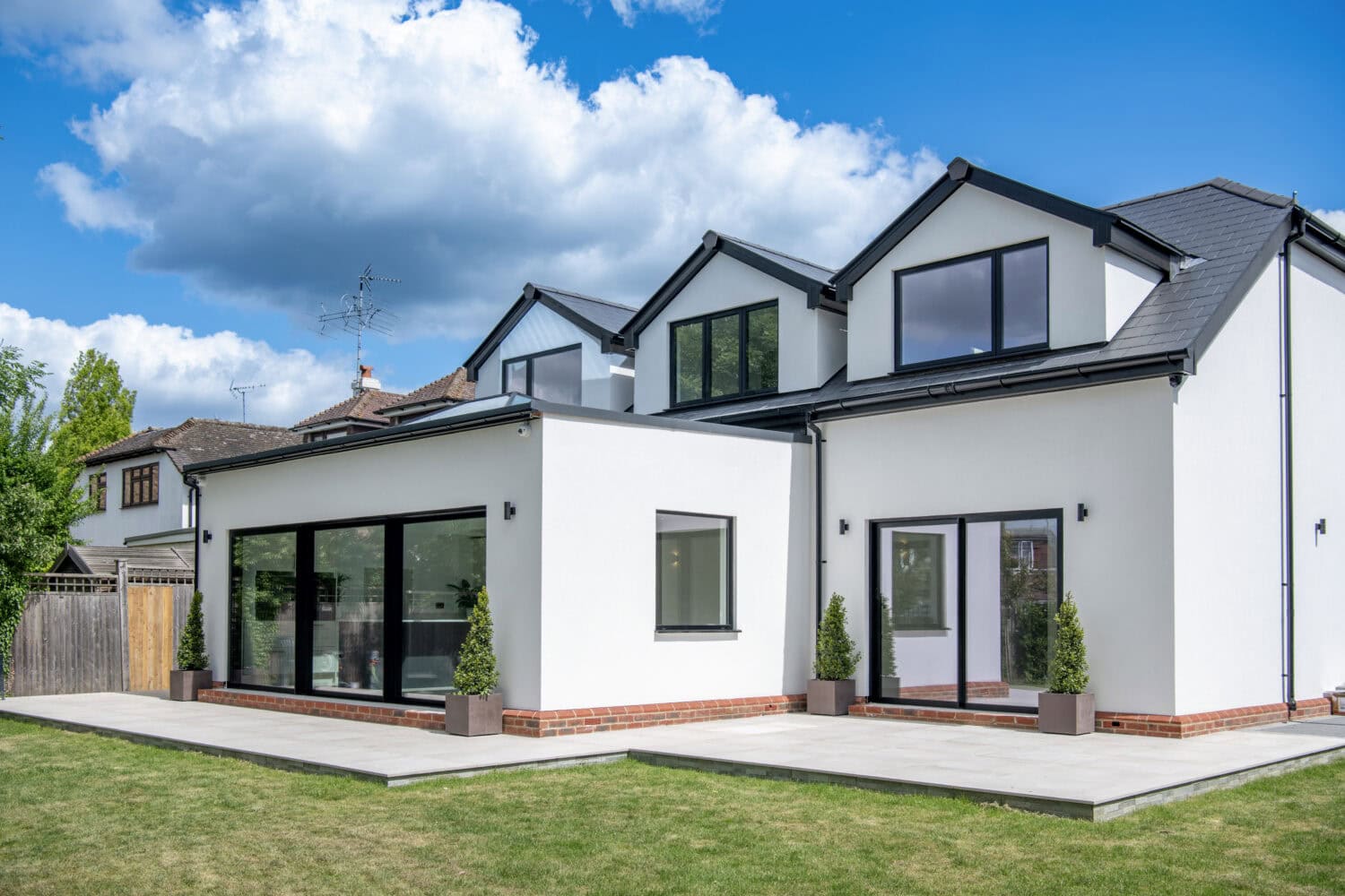Elegant bi-folding doors opening to a spacious garden patio, enhancing natural light and outdoor views. Perfect for contemporary homes seeking seamless indoor-outdoor living solutions.