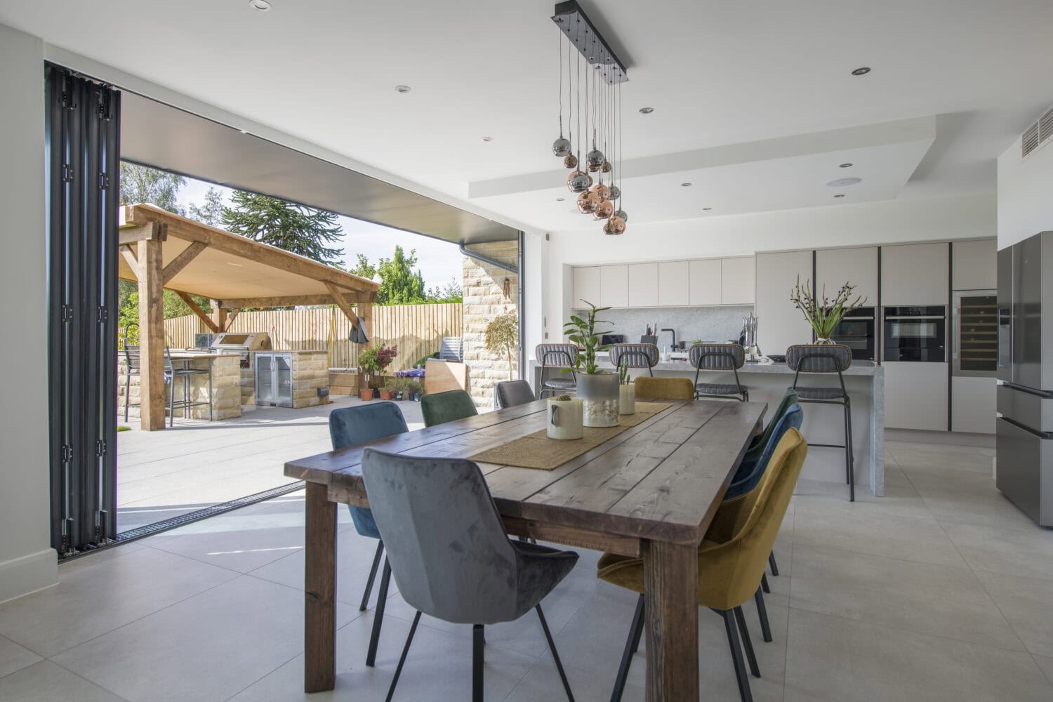 Aluminium bifold doors opening to a stylish outdoor patio, showcasing sleek external aluminium bifold doors that enhance indoor-outdoor living spaces with durability and contemporary design.