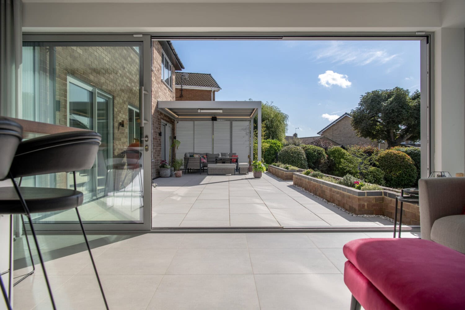 High-quality bi-folding doors opening to a spacious outdoor patio in Firs Drive, Harrogate. Enhance your home with stylish, durable, and energy-efficient folding doors.