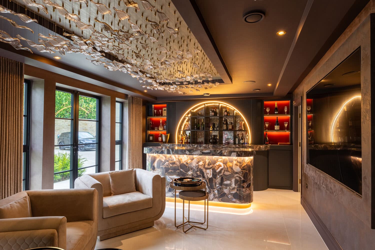 Elegant living room featuring large bi-folding doors opening to outdoor space.