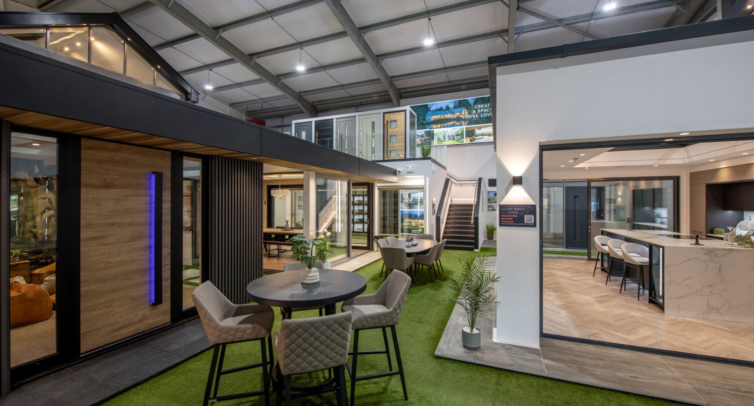 Bi-folding doors in a Glasgow showroom, showcasing sleek, high-quality aluminium frames that open up living spaces to outdoor areas, perfect for contemporary home designs.
