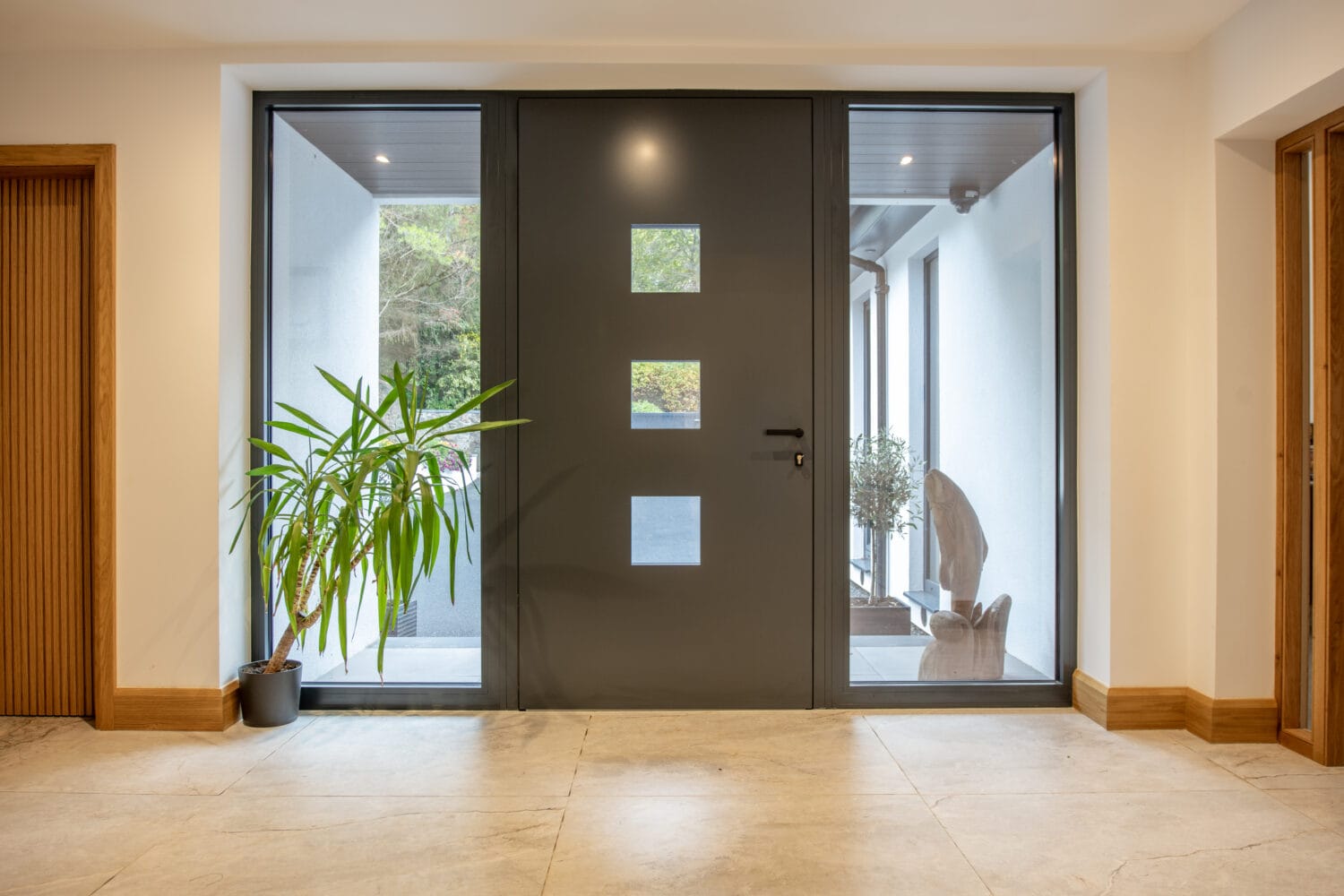 Elegant black bi-folding doors with large glass panels, ideal for connecting indoor living spaces to the garden. Customisable, energy-efficient, and designed for seamless outdoor-indoor flow.