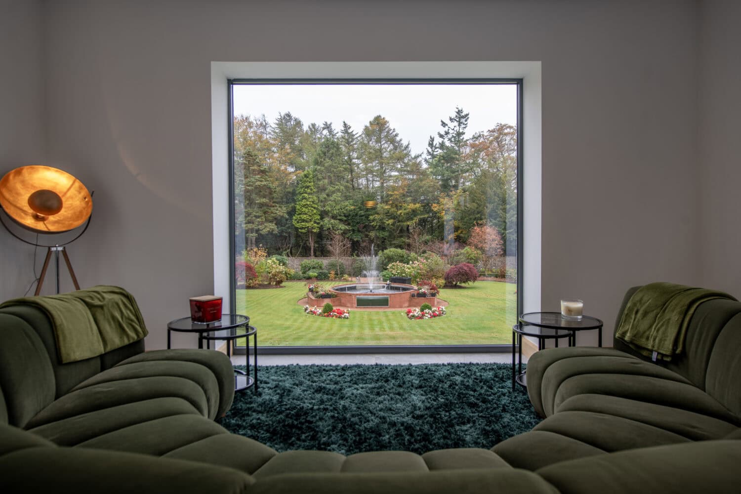 Bi-Folding doors opening to a beautiful garden in Aberdeen, showcasing seamless indoor-outdoor living with stylish, energy-efficient glass panels.