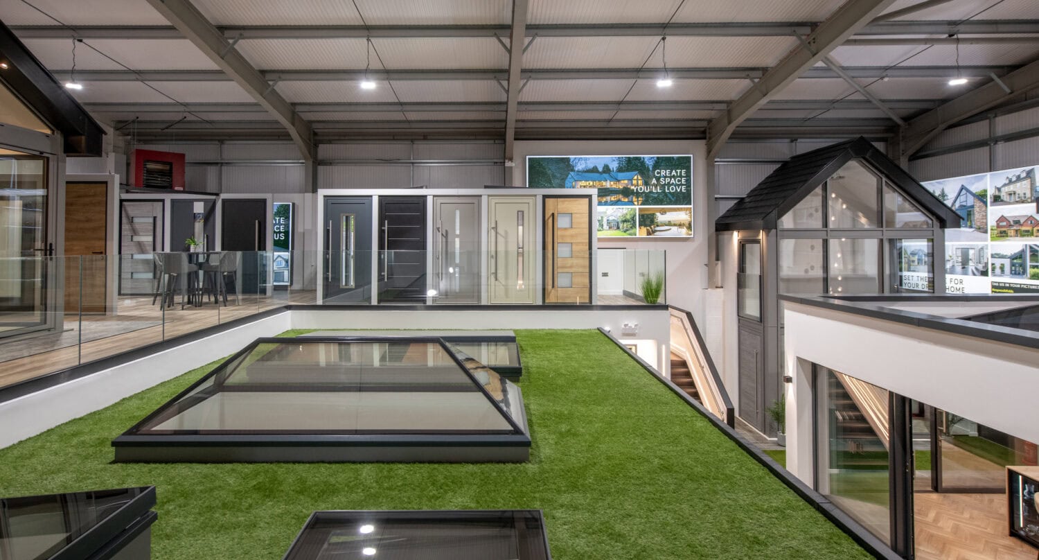 Elegant bi-folding doors displayed in Glasgow showroom for modern home transformation.