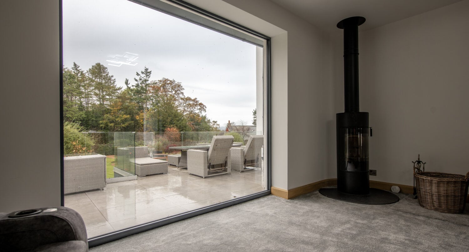 Bi-Folding doors opening to outdoor patio with garden views in Aberdeen.
