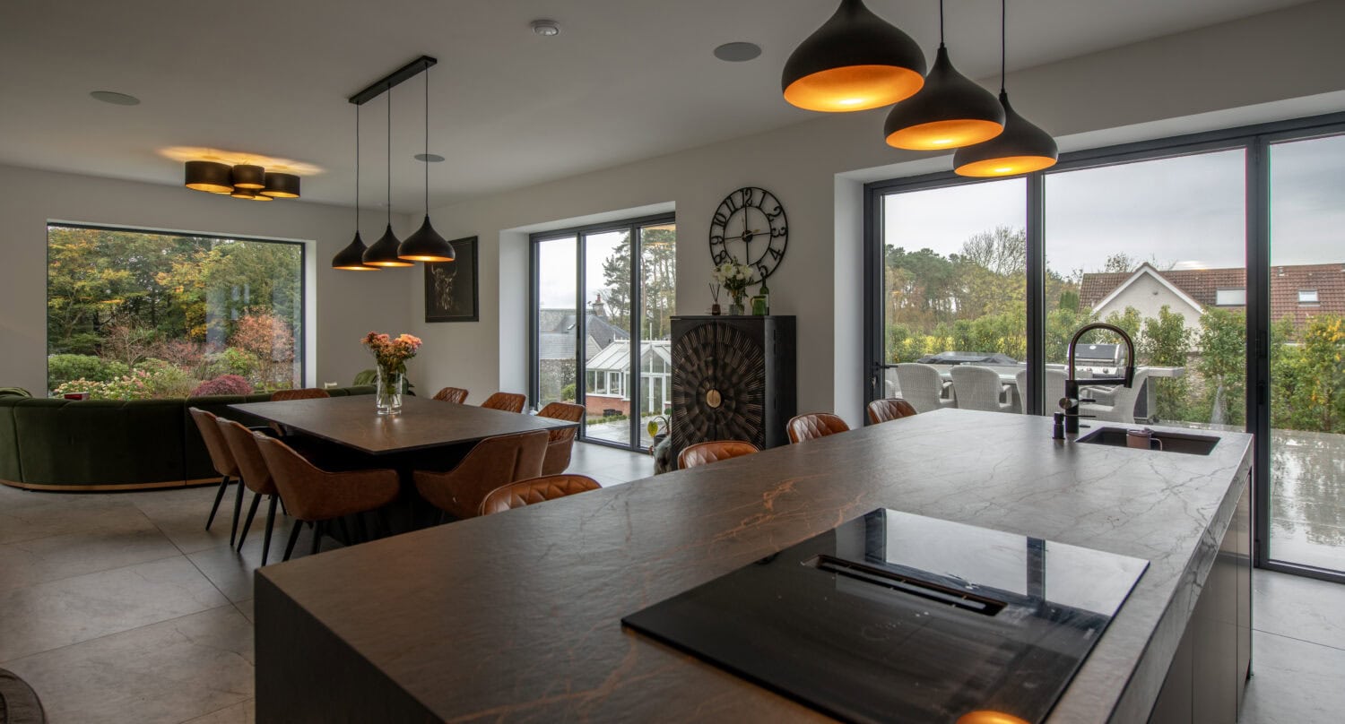 Elegant bi-folding doors opening to the garden, providing seamless indoor-outdoor living space. High-quality aluminium bi-folds enhance natural light and outdoor views.