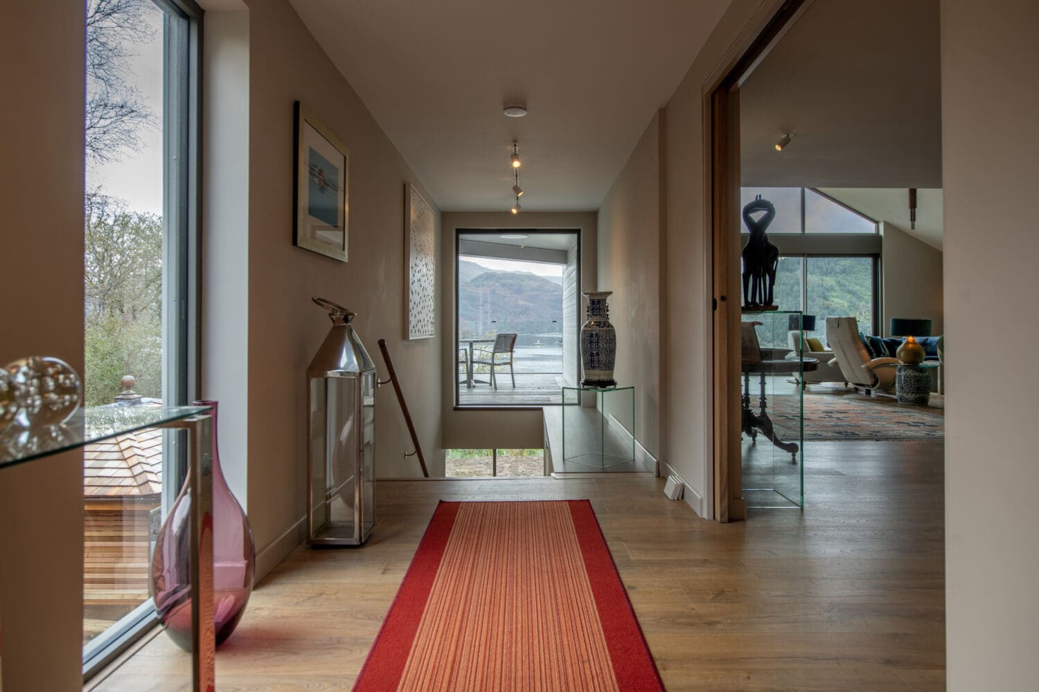 High-quality bi-fold doors opening into a modern Helensburgh home, offering seamless indoor-outdoor living with large glass panels and aluminium frames.