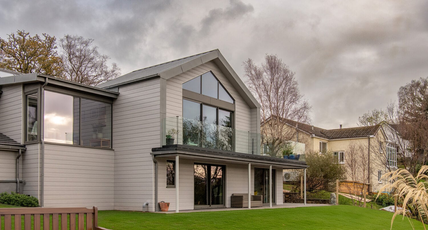 Norse Lodge featuring large bi-folding doors opening to a lush garden in Helensburgh, showcasing contemporary design and seamless indoor-outdoor living with high-quality express bi-fold doors.