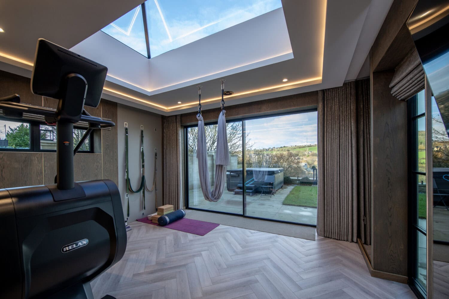 High-quality XP Glide bi-fold doors providing seamless indoor-outdoor living with large glass panels and smooth operation.
