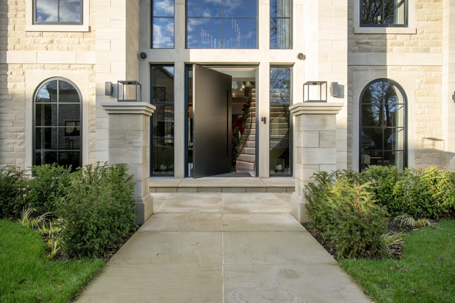 Elegant pivot doors with sleek black finish, enhancing the contemporary look of the building's entrance. Perfect for stylish homes and commercial properties.