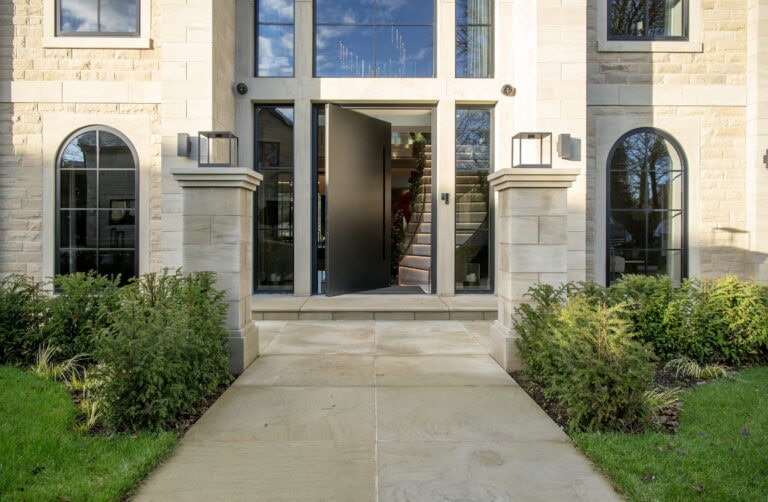 Elegant pivot doors with sleek black finish, enhancing the contemporary look of the building's entrance. Perfect for stylish homes and commercial properties.