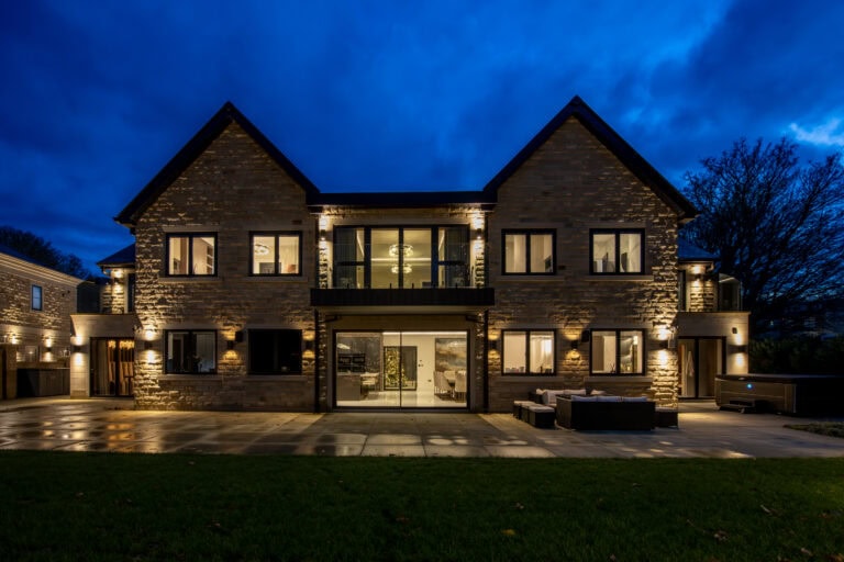 High-quality bi-folding doors opening to a modern home exterior.