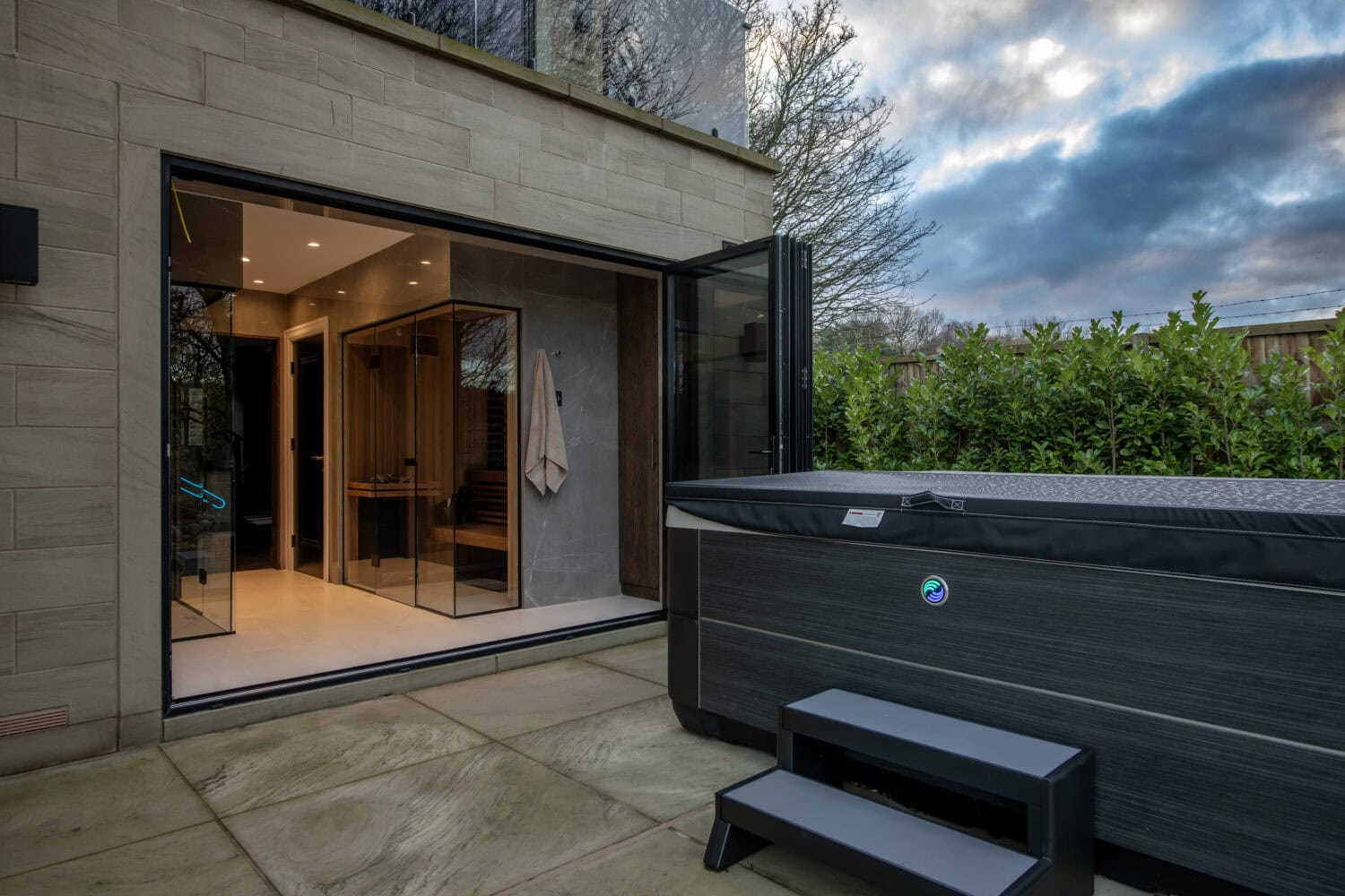 Stylish steel-look bi-fold doors opening to outdoor space, enhancing modern home aesthetics and functionality. Perfect for seamless indoor-outdoor living with durable, sleek design.