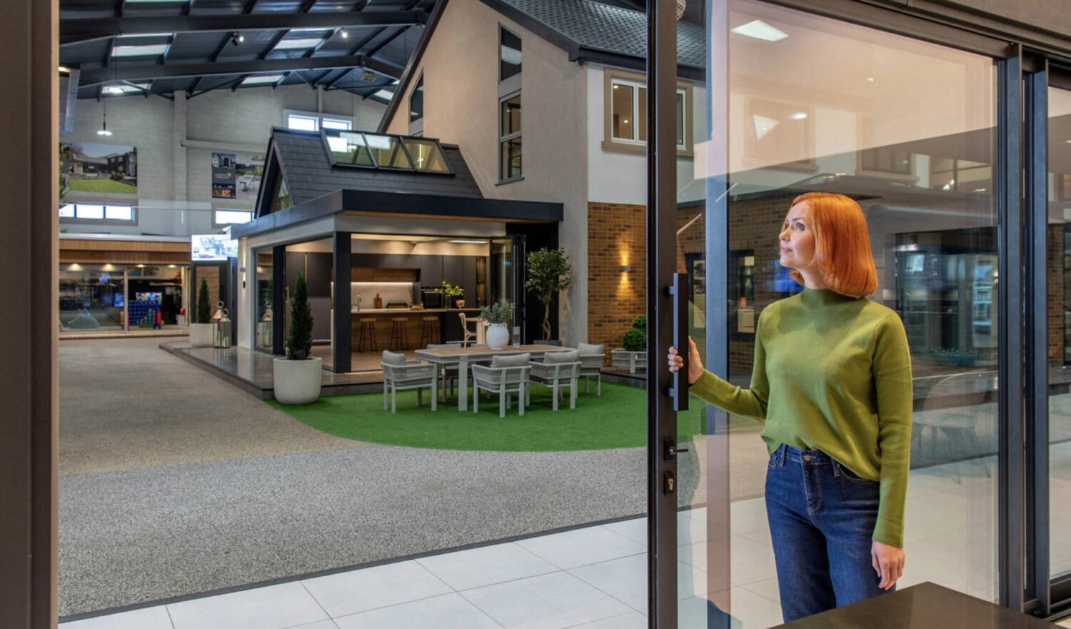Elegant bi-folding doors opening to a stylish outdoor patio, showcasing seamless indoor-outdoor living with high-quality aluminium frames and large glass panels.