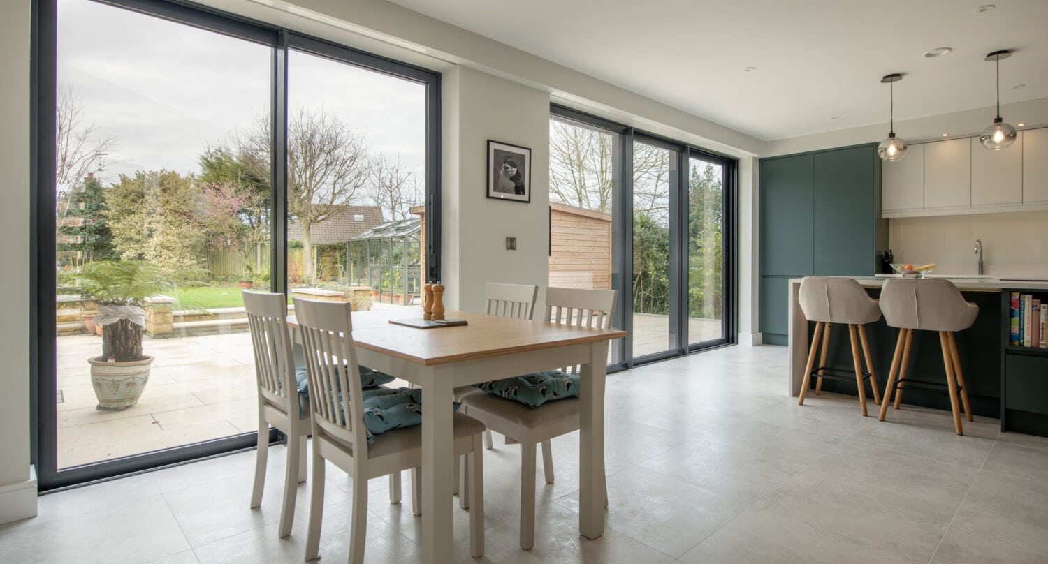 Large glass bi-folding doors in Chapel Grove home, providing seamless indoor-outdoor living and natural light. Perfect for stylish, energy-efficient home upgrades.