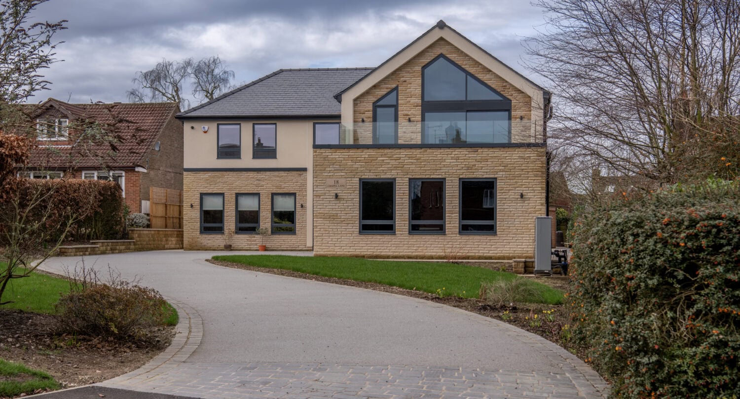 Bi-folding doors at Chapel Grove home, offering seamless indoor-outdoor living with stylish, high-quality glazing. Ideal for modern homes seeking to maximise space and light.