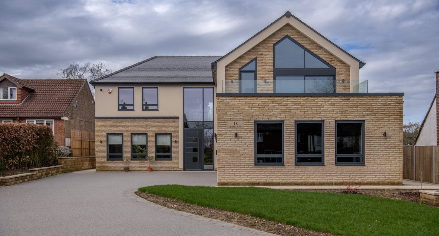 Elegant bi-folding doors opening to the garden at Chapel Grove residence, showcasing contemporary design and seamless indoor-outdoor living.