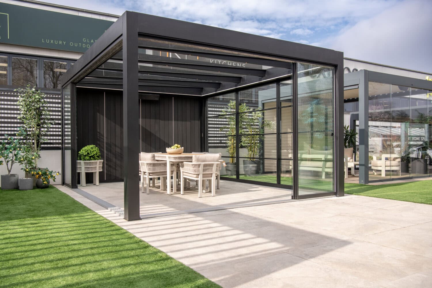 Elegant outdoor dining area featuring bi-fold doors that seamlessly connect indoor and outdoor living spaces.