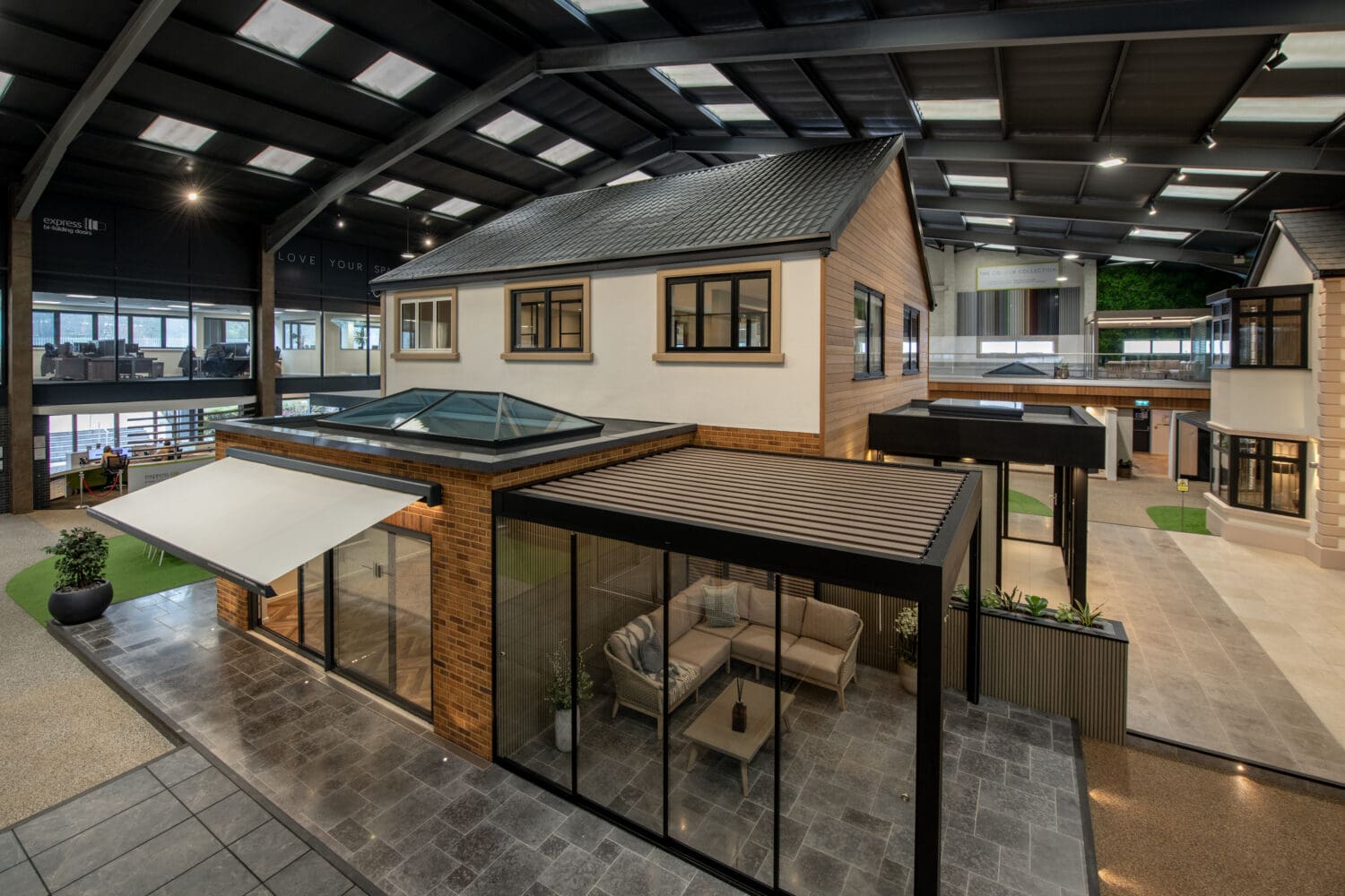 An interior view of a Leeds showroom showcasing stunning bi-folding doors, contemporary furniture, and a spacious, well-lit environment perfect for home transformation projects.