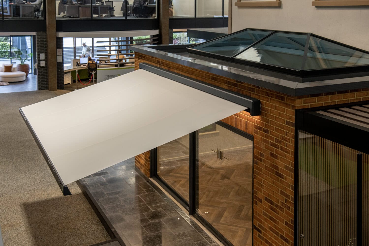 Contemporary Leeds showroom featuring bi-folding doors and large skylights, showcasing stylish indoor-outdoor living solutions and modern architectural design.