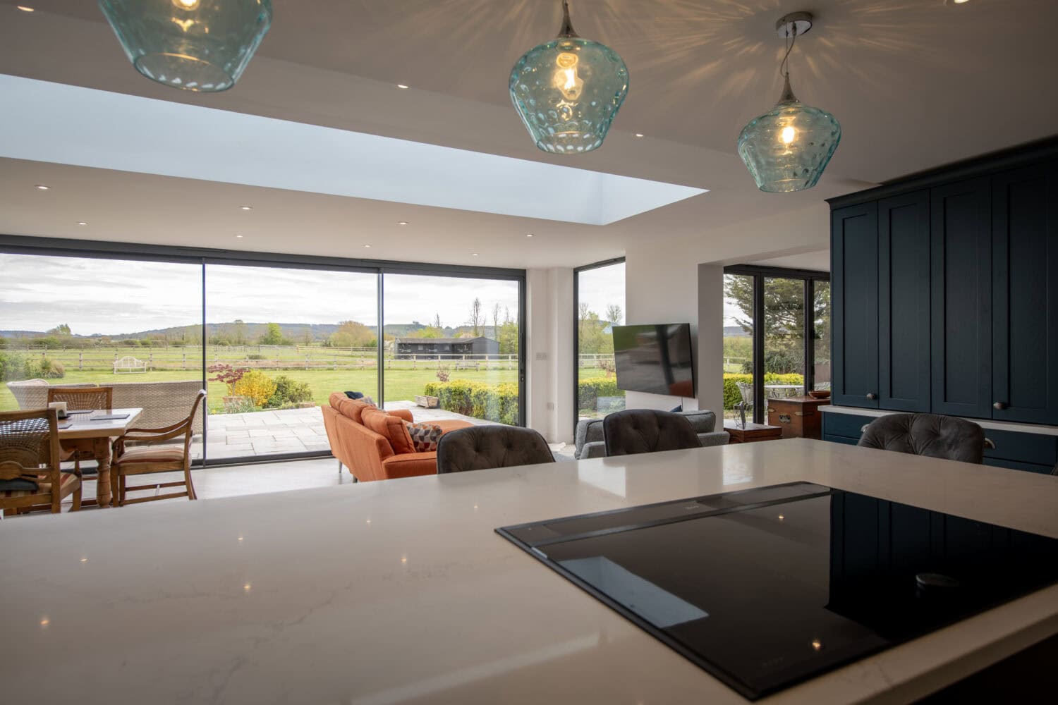 Bi-Folding doors opening to a scenic outdoor view, enhancing natural light and indoor-outdoor flow. Perfect for stylish, functional home improvements.