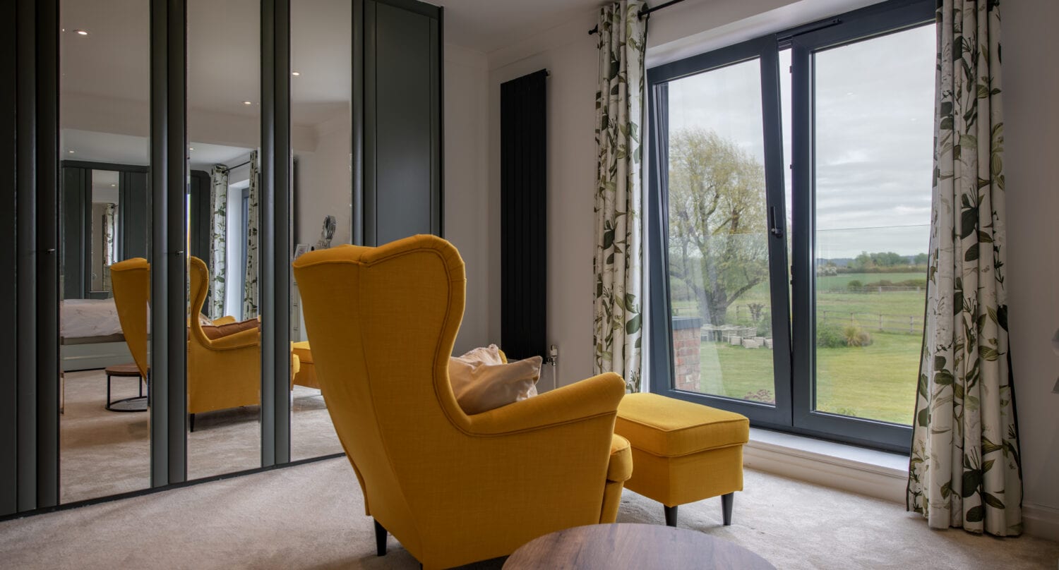 Elegant living room with large bi-folding doors opening to garden.