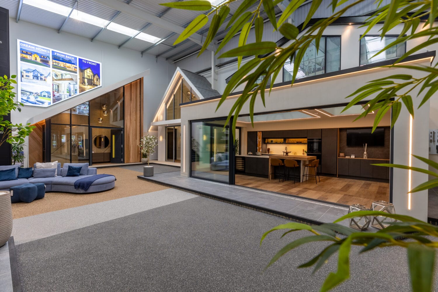 Elegant Milton Keynes showroom featuring modern bi-folding doors that seamlessly connect indoor and outdoor living spaces, showcasing high-quality aluminium designs.