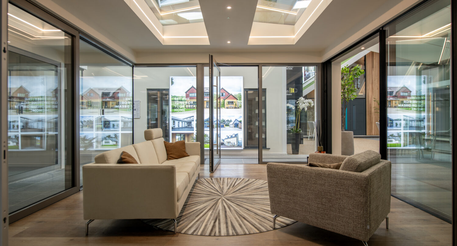 Modern Milton Keynes showroom featuring large bi-folding doors opening to outdoor space, showcasing stylish interior design and natural light.