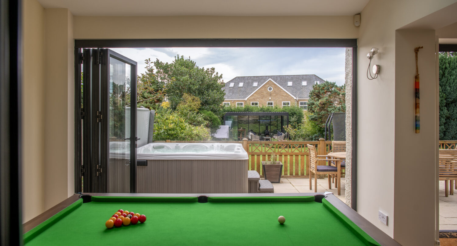 Modern bi-folding doors opening to a garden patio, enhancing outdoor living space with natural light and seamless indoor-outdoor transition.