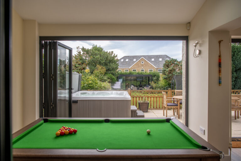 Modern bi-folding doors opening to a garden patio, enhancing outdoor living space with natural light and seamless indoor-outdoor transition.