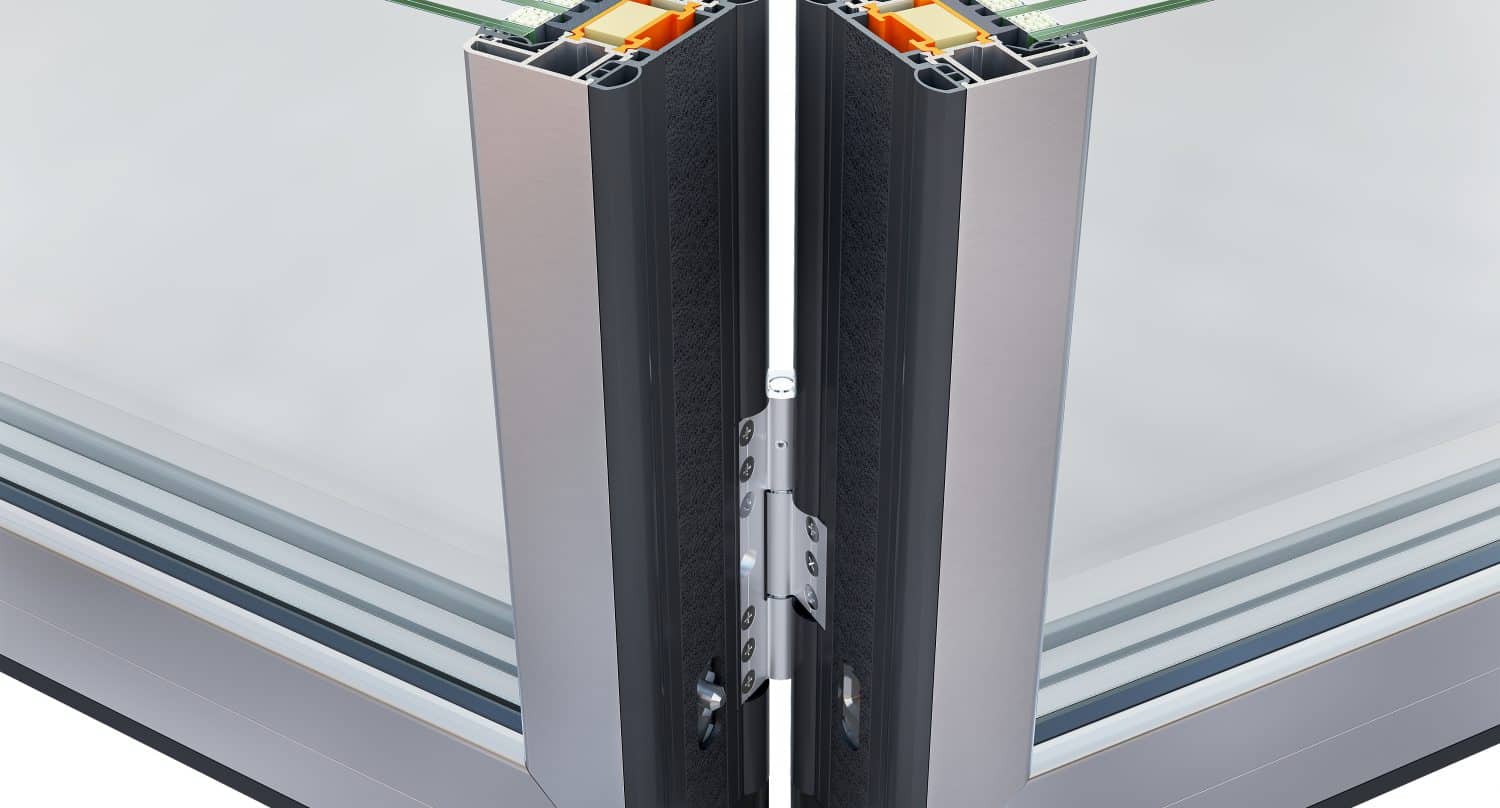 Close-up view of two aluminum-framed bifold doors meeting at a hinge, showing the detailed construction, layered glass panels, and internal orange components within the metal frames—an example of bespoke glass solutions.