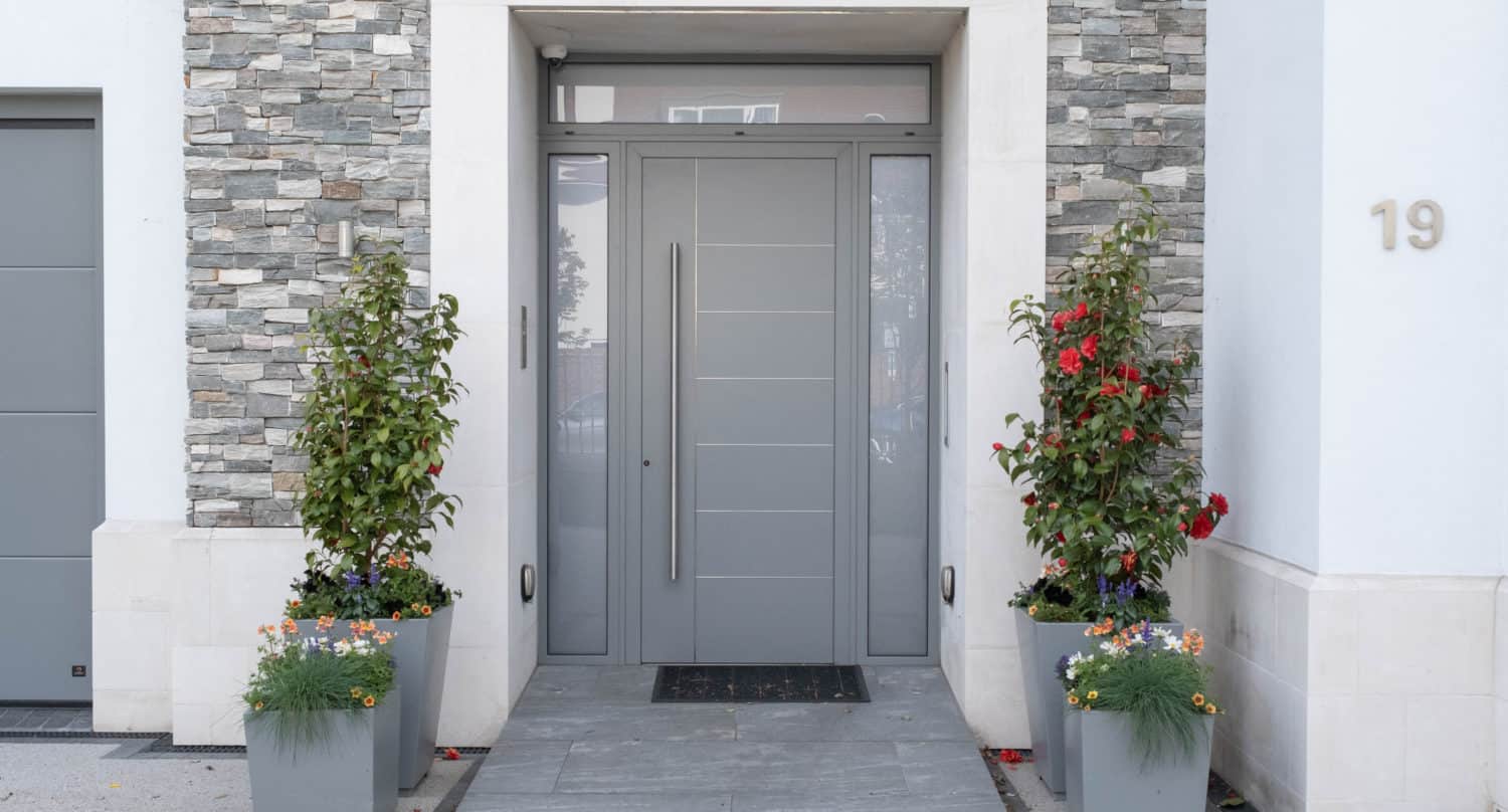 Contemporary grey front door with glass side panels and top window
