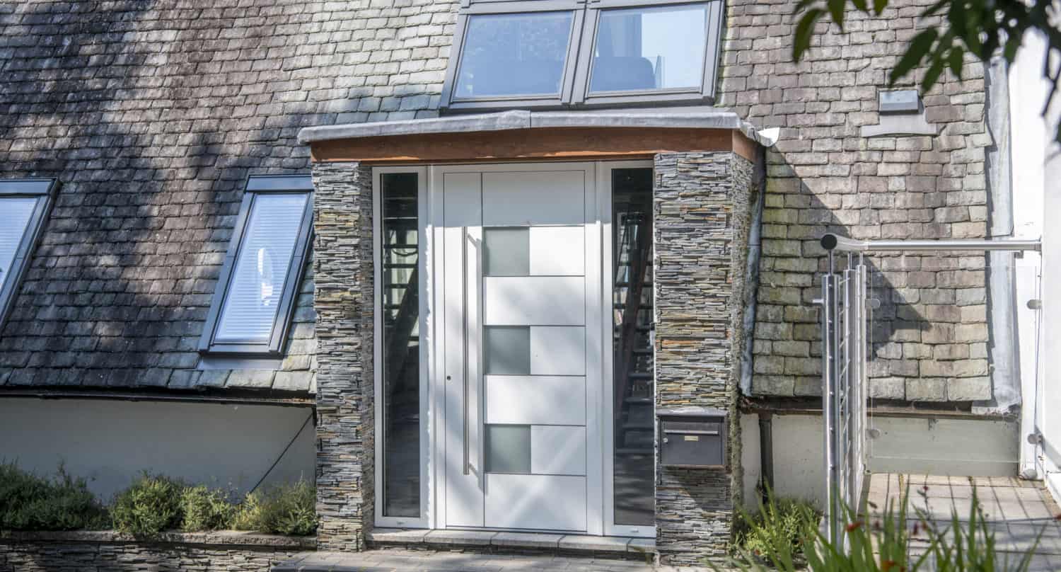 White front door with 3 square glazed windows and side panels