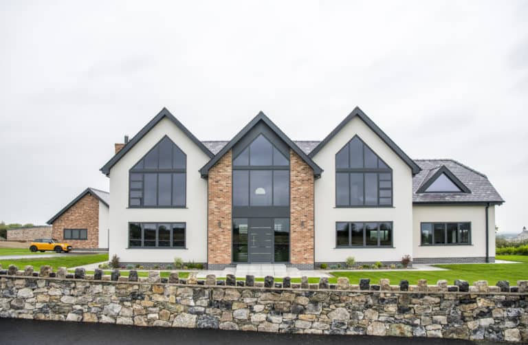 Luxury new build home featuring shaped aluminium windows and entrance door