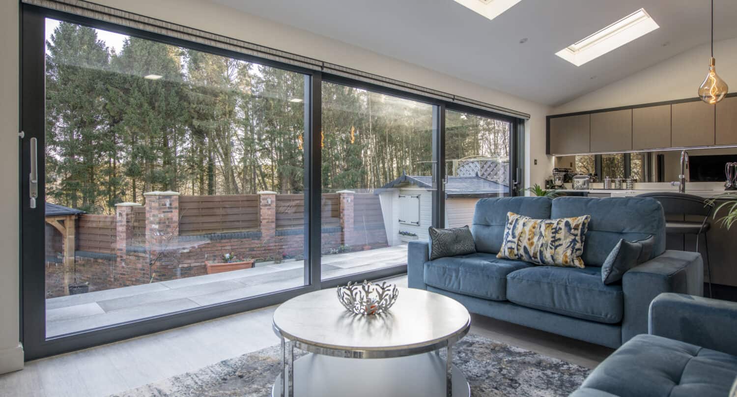 Living room space featuring glass sliding doors in overlooking garden
