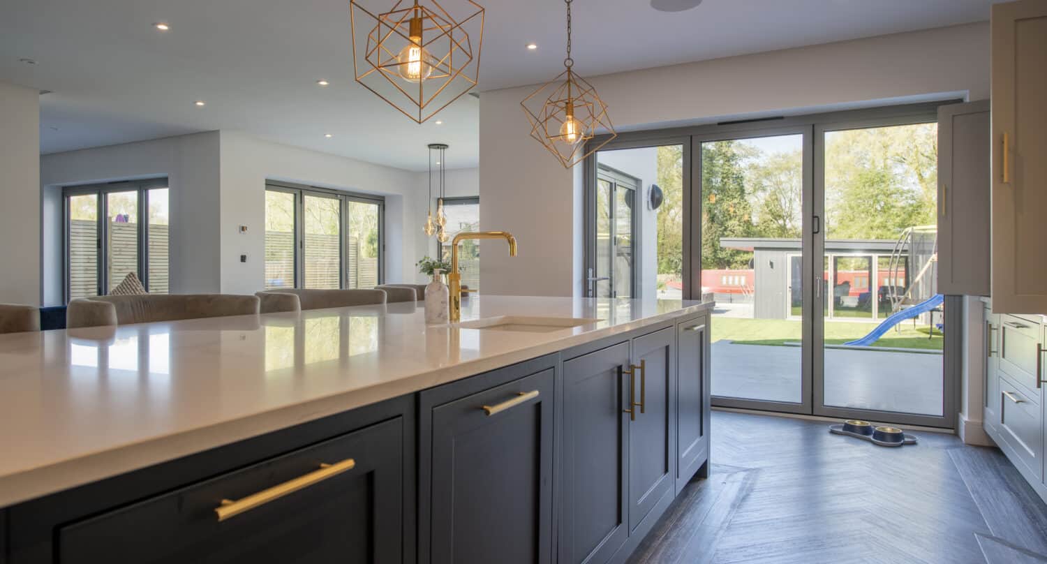 Dining area with round dining table and aluminum bifold doors
