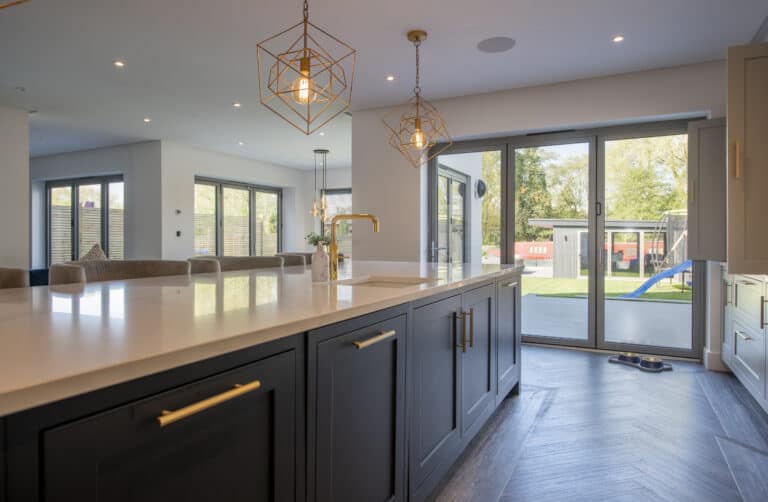 Dining area with round dining table and aluminum bifold doors