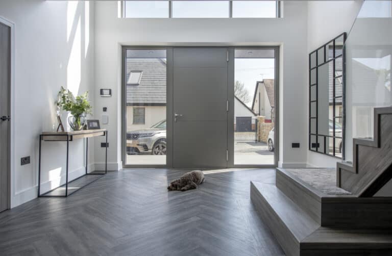 Modern hallway featuring a linear 4 panel aluminium front door with sidelights