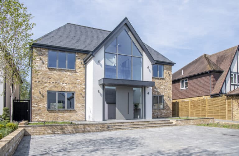 Luxury detached house featuring grey windows and modern from door with side panels