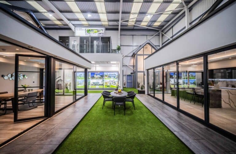 Bi Folding and sliding door showroom, featuring single house extensions and an outdoor space with a garden table