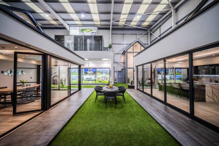Bi Folding and sliding door showroom, featuring single house extensions and an outdoor space with a garden table