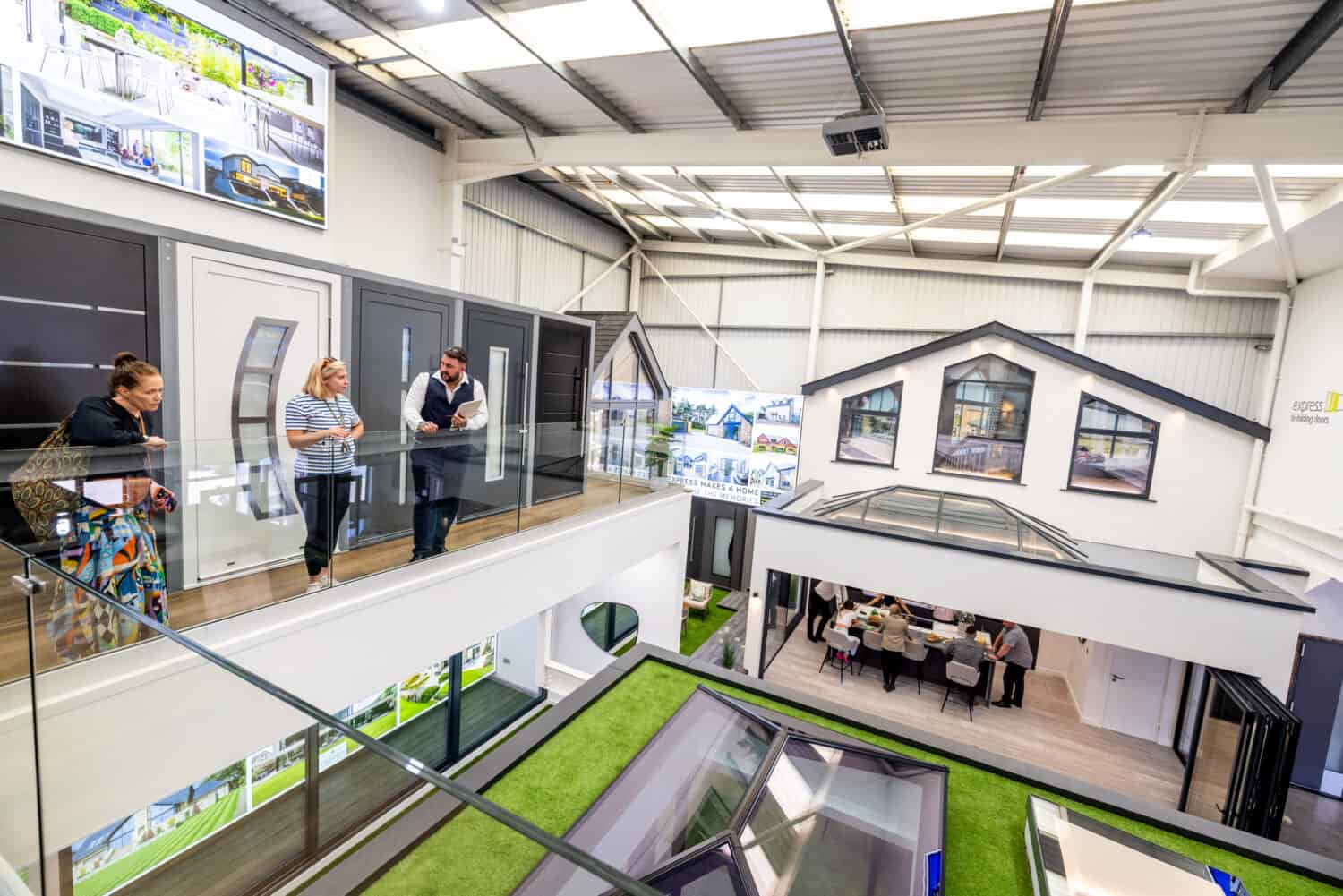 A few people walking around a bifolding and entrance doors showroom