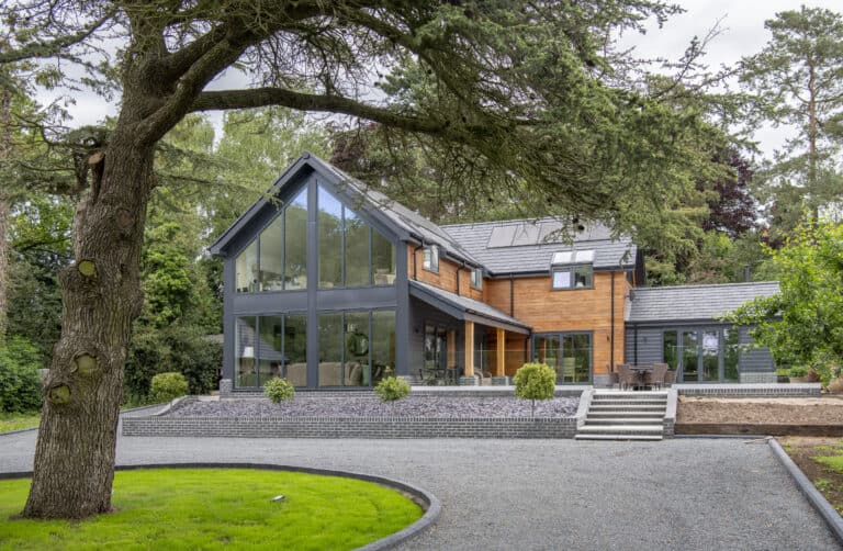 Luxury modern home featuring black aluminium curtain walling and bi folding doors